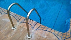Pool safety net fitted around steps.