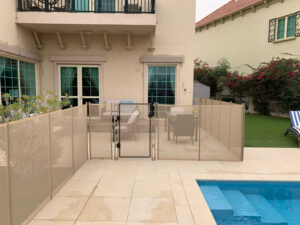 Child-safety-fence-to-safeguard-access-to-a-community-pool-beige-colourbeige