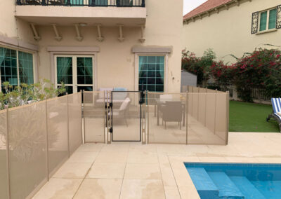 Child-safety-fence-to-safeguard-access-to-a-community-pool-beige-colourbeige