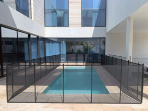 swimming-pool-child-safety-fence-Dubai-clear-with-black-trim-and-poles