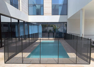 swimming-pool-child-safety-fence-Dubai-clear-with-black-trim-and-poles